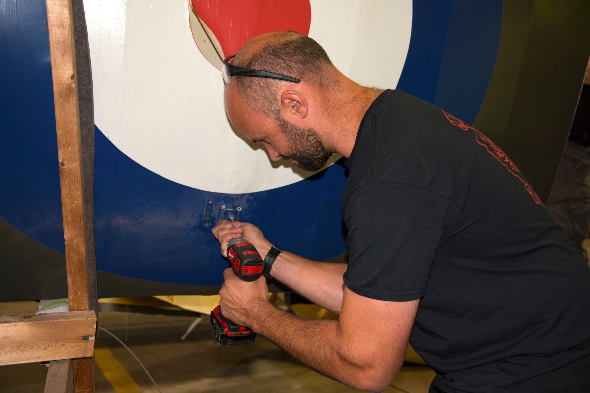 DAYTON, Ohio -- Museum restoration specialist Adam Naber remove wing supports on the Avro 504K which was originally built in 1966 by the Royal Canadian Air Force's Aircraft Maintenance & Development Unit. Preserving the Air Force's proud legacy, the Restoration Division restores aircraft and aerospace vehicles to historically accurate and visually striking levels. (U.S. Air Force photo by Ken LaRock)