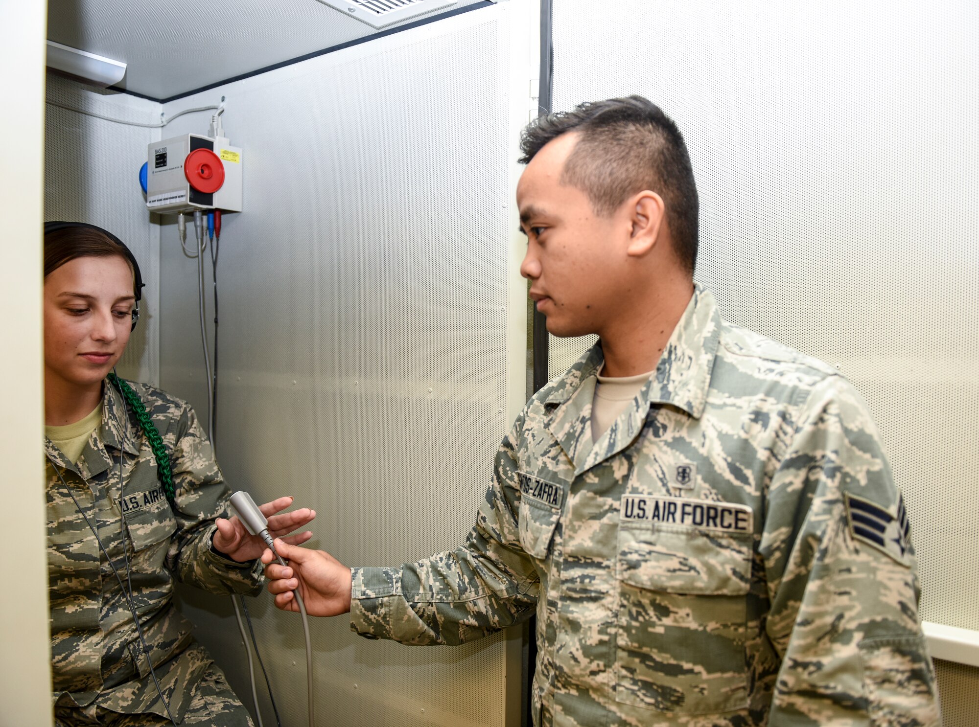 U.S. Air Force Senior Airman John Santos Zafra, 17th Medical Operations Squadron public health technician, conducts a hearing test with Airman Amberlee Welsh, 315th Training Squadron student, Goodfellow Air Force Base, Texas, Sept. 24, 2018. Zafra waited 4 1/2 years to become a naturalized citizen, starting the process in basic training (U.S. Air Force photo by Aryn Lockhart/Released).