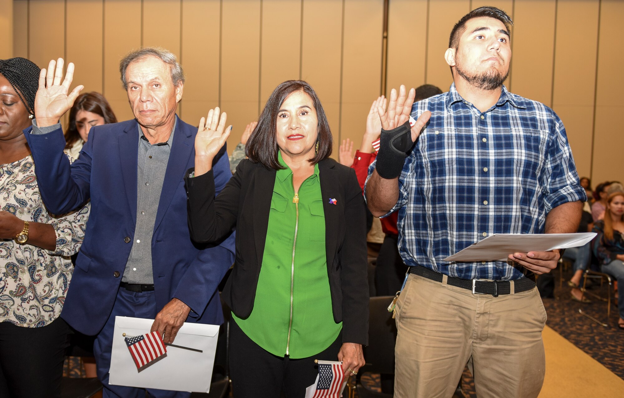 Angelo Inn housekeeper, Rosa Drake, takes her citizenship oath during the naturalization ceremony held at the CJ Davidson Center on Angelo State University, San Angelo, Texas, Sept. 25, 2018. Drake took classes through a partnership agreement with Howard University and Goodfellow Air Force Base that helped her to achieve U.S. citizenship. (U.S. Air Force photo by Aryn Lockhart/Released)