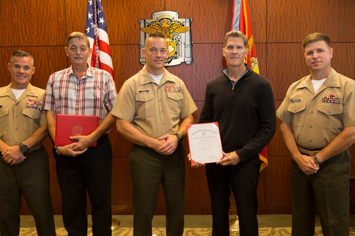 Marine Corps Recruit Depot, San Diego, California – Mr. David A. Drzewiecki and Mr. Richard E. Myrick stand proudly with the Marine Corps Recruit Depot and Western Recruiting Region Chief of Staff, and their respective assistant chiefs of staff after receiving length of service awards aboard the depot October 4, 2018.