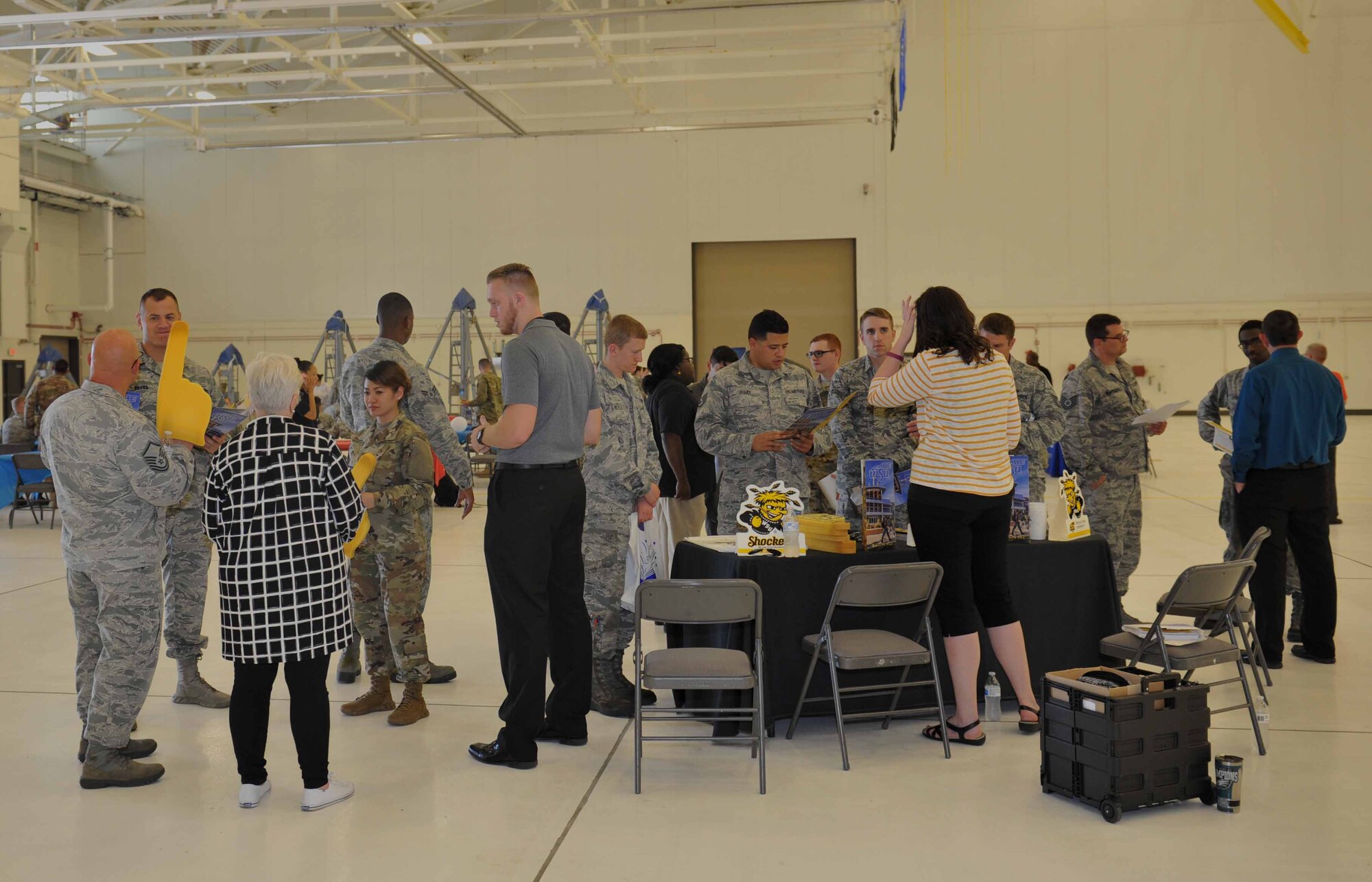 Airmen and education providers discuss different education opportunities at the education fair Oct. 2, 2018, at McConnell Air Force Base, Kansas. The education fair introduced Wichita State University as one of the newest schools on base for Airmen to attend. (U.S. Air Force photo by Staff Sgt. David Bernal Del Agua)