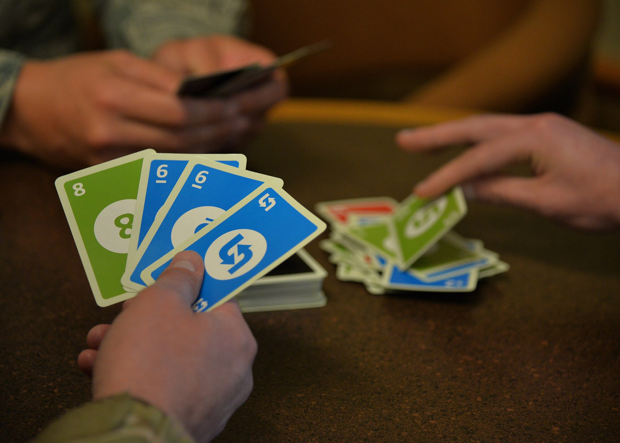 Airmen demonstrate a card game Aug. 27, 2018, at the Grizzly Bend at Malmstrom Air Force Base, Mont.