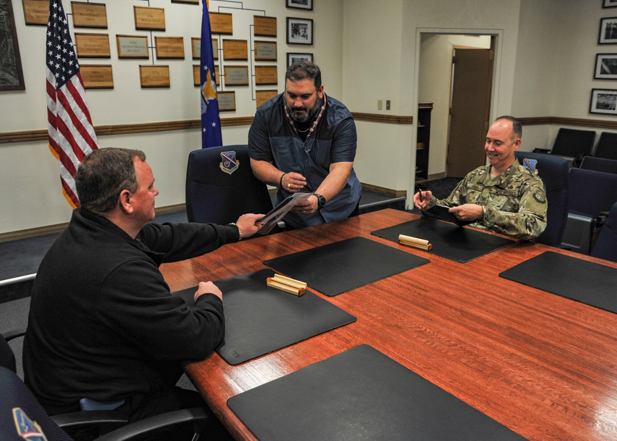 Left to right:  Tommy Hobson, president for the American Federation of Government Employees (local 2263), Steve Jansen, Kirtland's Labor Relations officer, and 377th Air Base Wing Commander Col. Richard Gibbs complete the signing of a new labor agreement Oct. 4, 2018 here. The agreement supplements the master labor agreement reached between the AFGE Council 214 and Air Force Materiel Commander in May of 2017. The new agreement runs through 2020, but can be extended in three-year increments thereafter, if both parties agree. (U.S. Air Force photo by Jim Fisher)