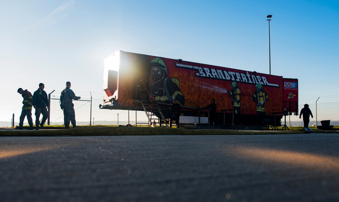 U.S. Air Force Airmen prepare to conduct live-fire structural burn training at Spangdahlem Air Base, Germany, Oct. 4, 2018. The event was part of the fire department's career field training plan to meet annual training requirements. The day's events kicked off Fire Prevention Week. (U.S. Air Force photo by Airman 1st Class Valerie Seelye)
