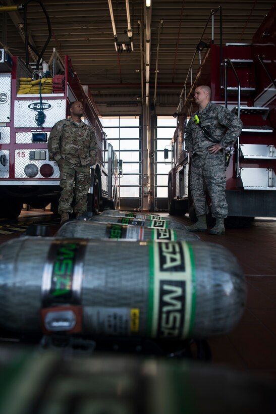U.S. Air Force Master Sgt. Darnell Dobson, 52nd Civil Engineer Squadron training assistant chief, left, and Staff Sgt. Mathew King, 52nd CES crew chief, right, prepare to conduct live-fire structural burn training at Spangdahlem Air Base, Germany, Oct. 4, 2018. The training kicked off Fire Prevention week, an annual event held in remembrance of the Great Chicago Fire of 1871, one of the most destructive fires in U.S. history. The Chicago fire sparked the start of building standards, firefighting strategies, and public fire safety education. (U.S. Air Force photo by Airman 1st Class Valerie Seelye)