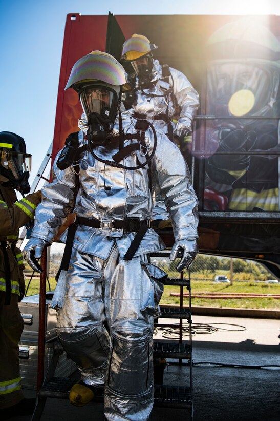 U.S. Air Force Col. Tad Clark, 52nd Fighter Wing vice commander, back, and Lt. Col. Troy Kirk, 52nd Mission Support Group deputy commander, front, complete live-fire structural burn training at Spangdahlem Air Base, Germany, Oct. 4, 2018. The training was held in observance of Fire Prevention Week, which educates Spangdahlem personnel on fire safety standards. (U.S. Air Force photo by Airman 1st Class Valerie Seelye)