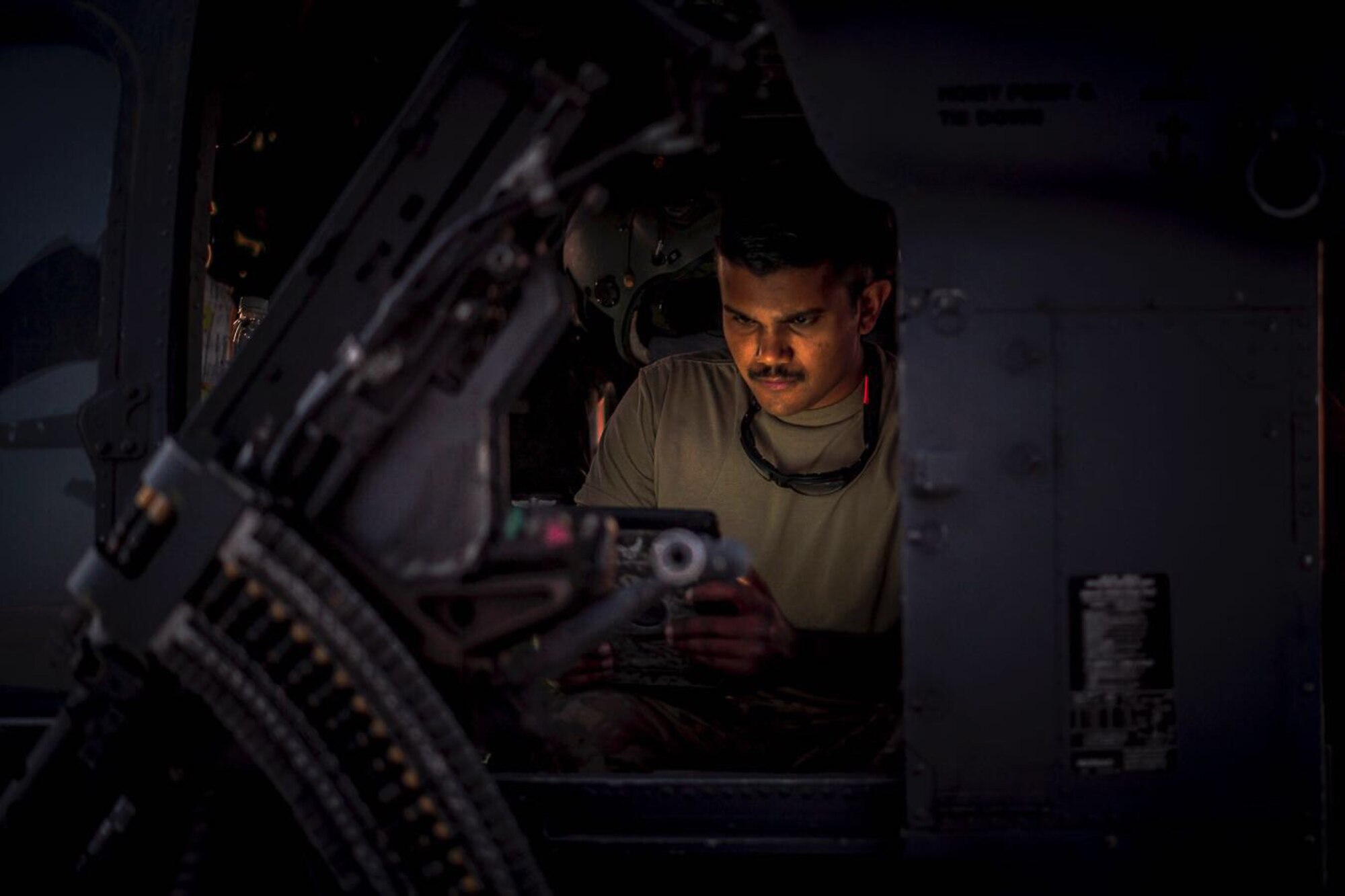 An Airman works on a helicopter