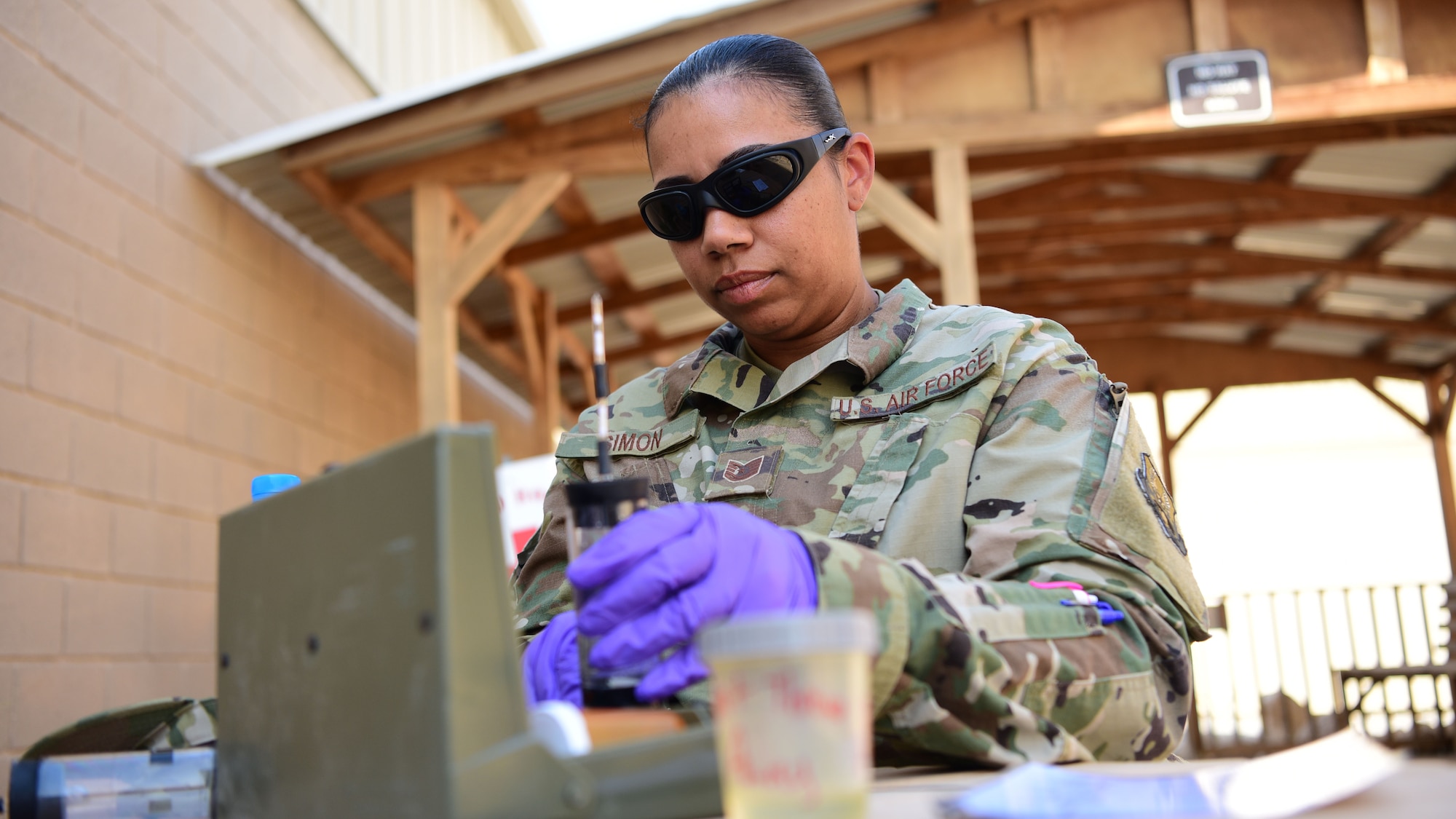 Tech. Sgt. Nakisha Simon, 386th Expeditionary Medical Group Bioenvironmental Engineering non-commissioned officer in charge, conducts a water sampling test Oct. 3, 2018, at an undisclosed location in Southwest Asia. Simon and her team perform numerous tests each week to ensure bottled water is safe for deployed personnel. (U.S. Air Force photo by Staff Sgt. Christopher Stoltz)