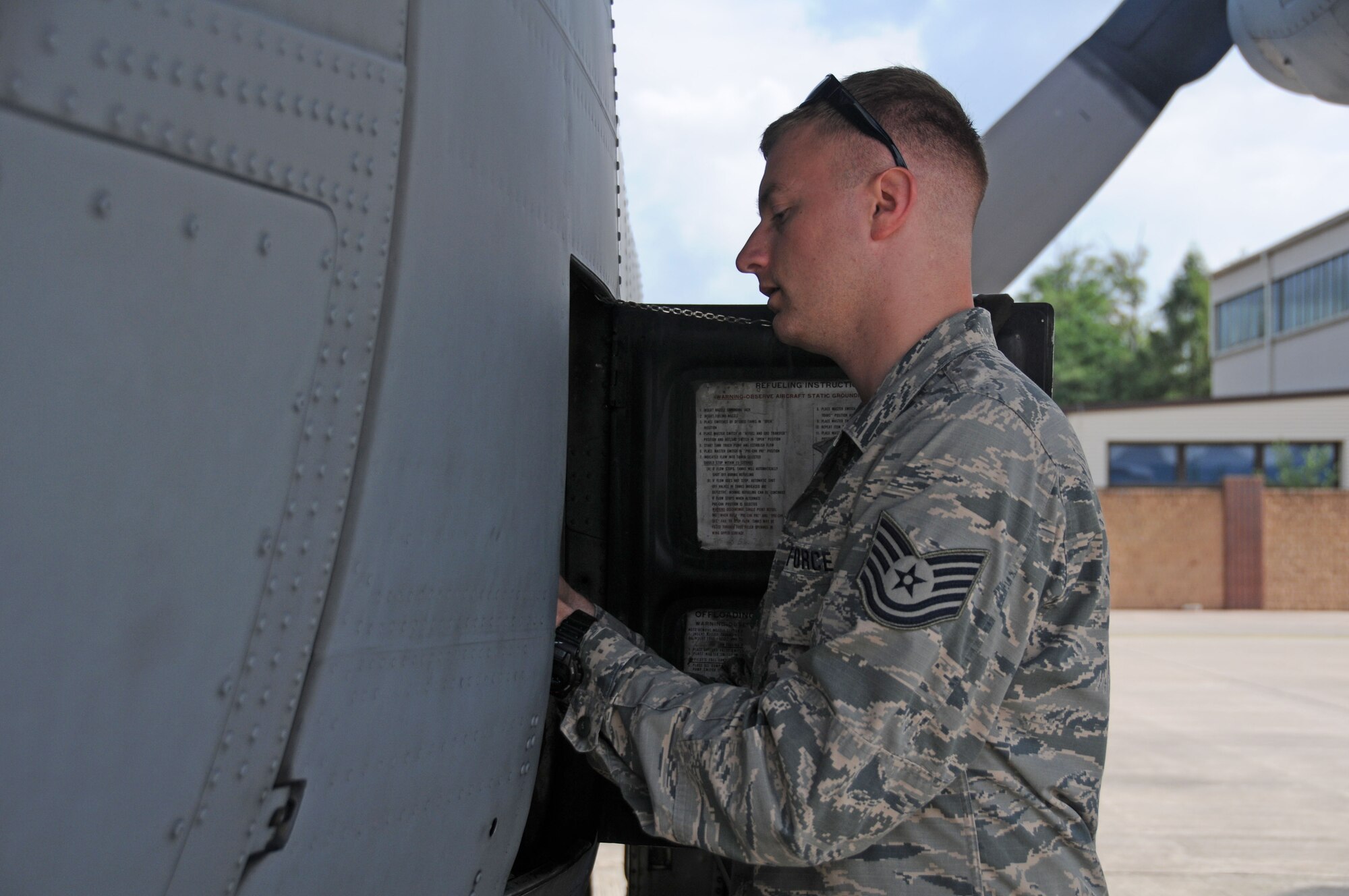 Tech. Sgt Joel Putnam, a 94th Aircraft Maintenance Squadron crew chief, prepares a C-130H3 Hercules for fueling at Ramstein Air Base, Germany June 14, 2018. Joel and his brother Jeremy are both assigned to the 94th Maintenance Group at Dobbins Air Reserve Base, Ga. (U.S. Air Force photo/Senior Airman Justin Clayvon)