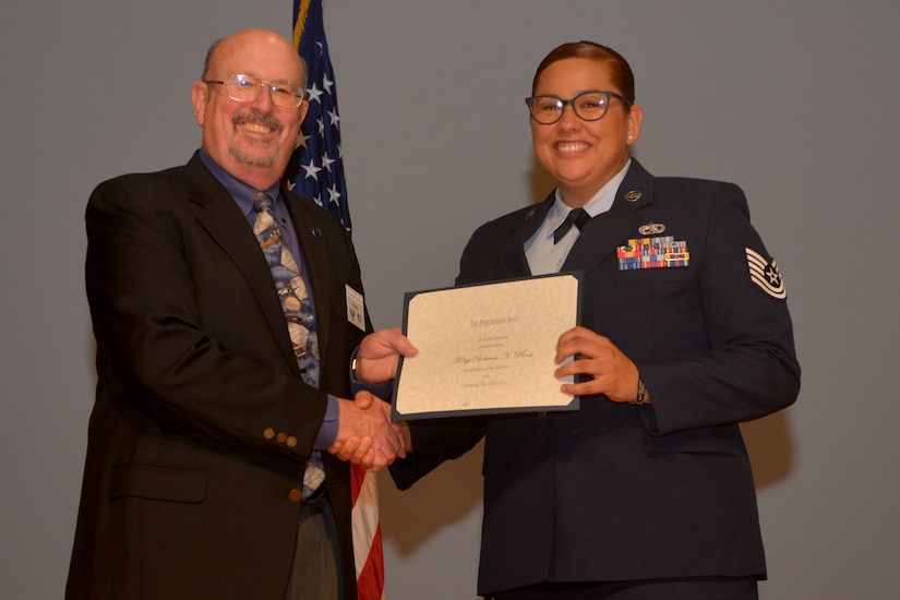 Retired Col. Brendel Kreighbaum presented the Pitsenbarger Award to Tech. Sgt. Rebecca Roa, 437th Aircraft Maintenance Squadron during a Community College of the Air Force ceremony Oct. 4, 2018 on Joint Base Charleston, S.C. The Pitsenbarger Award provides a one-time grant of $400 to selected Air Force enlisted personnel graduating from the CCAF who plan to pursue a bachelor’s degree.