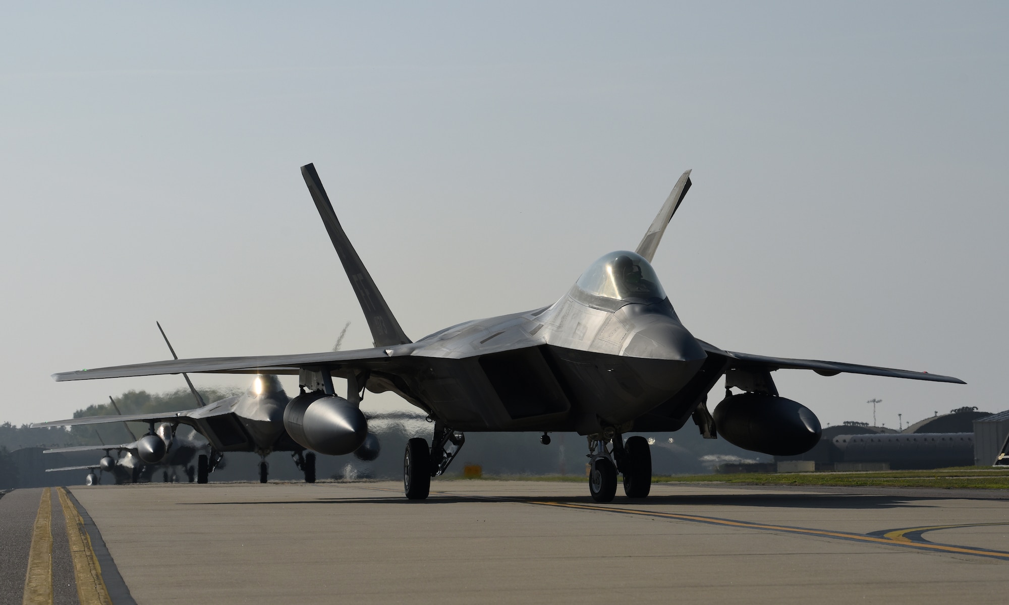 F-22 Raptors assigned to the 1st Fighter Wing, Joint Base Langley-Eustis, Va., taxi down the flightline at Royal Air Force Lakenheath, England, Oct. 5, 2018. As the world’s premiere operational 5th-generation fighter, the Raptor’s unique combination of stealth, speed, agility and situational awareness combined with lethal long-range air-to-air and air-to-ground weaponry make it the best air dominance fighter in the world. (U.S. Air Force photo/Staff Sgt. Alex Fox Echols III)