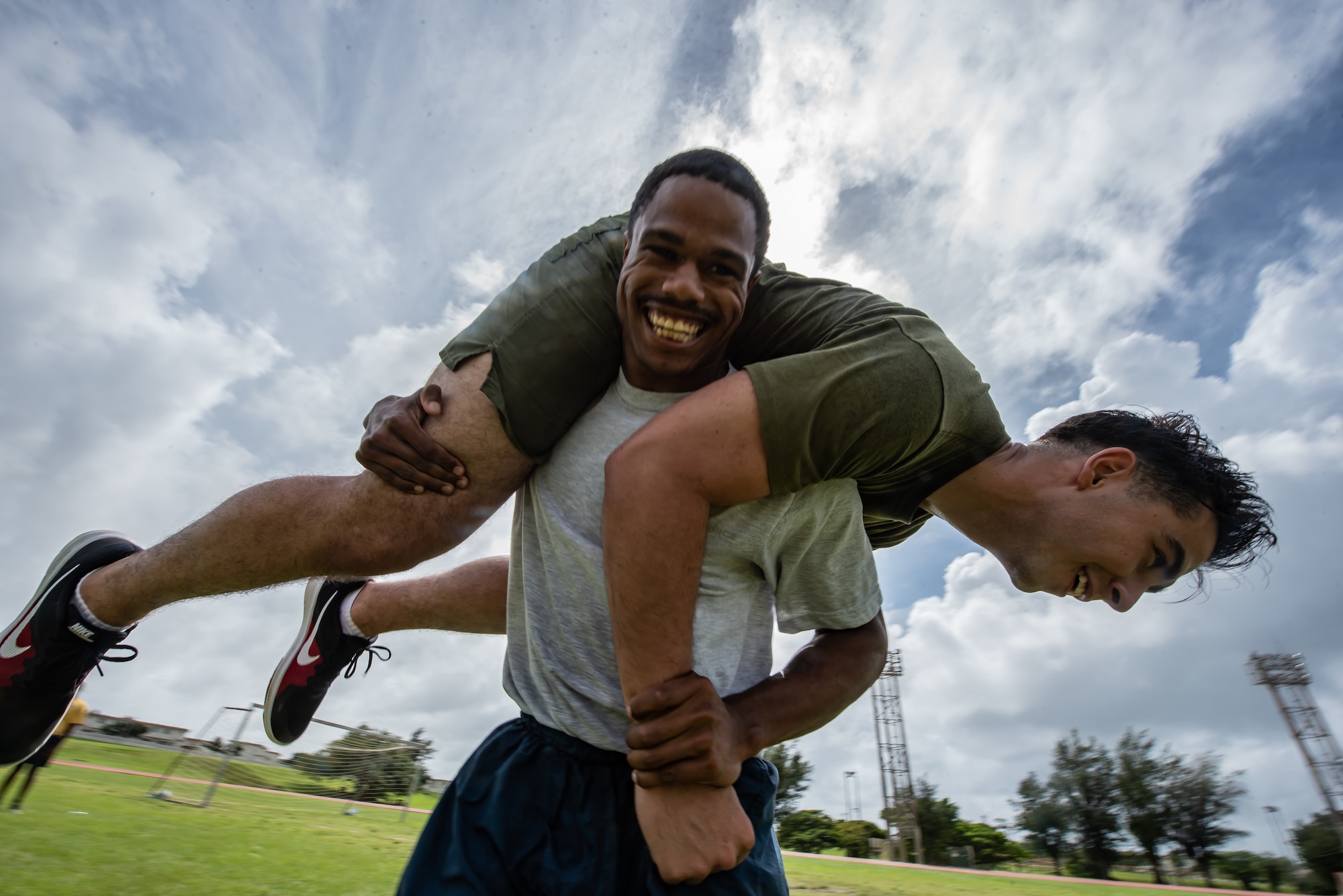 Air Force Staff Sgt. Amann Davis, Okinawa Joint Experience Red Team student, carries Marine Corps Sgt. Thomas Warren, OJE Red Team student, during the Okinawa Joint Fitness Challenge Sept. 26, 2018, at Kadena Air Base, Japan. The OJFC was designed to mimic obstacles and challenges faced in the battlefield such as sprinting, running ammunition cans, transporting wounded personnel to safety and tossing simulated grenades. (U.S. Air Force photo by Staff Sgt. Micaiah Anthony)