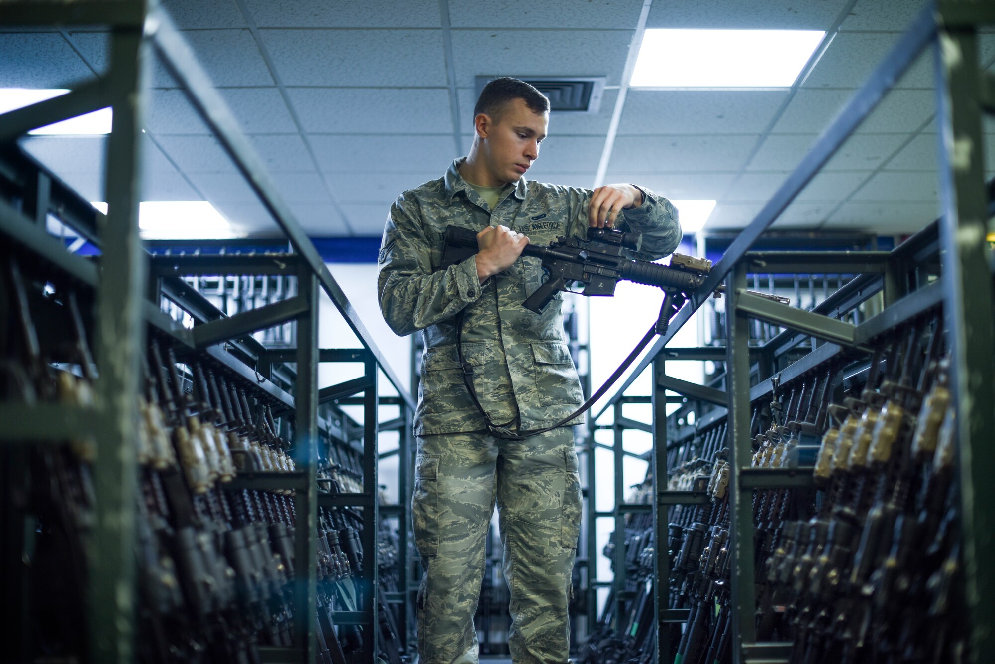 Airman 1st Class Nicholas Terry, 100th Security Forces Squadron armorer, inspects an M-4 carbine rifle at RAF Mildenhall, Great Britain, Sept. 25, 2018. After each shift, weapons must be cleared by security forces Airmen and then turned into the armory for security until the individual needs it again for duty. (U.S. Air Force photo by Airman 1st Class Brandon Esau)