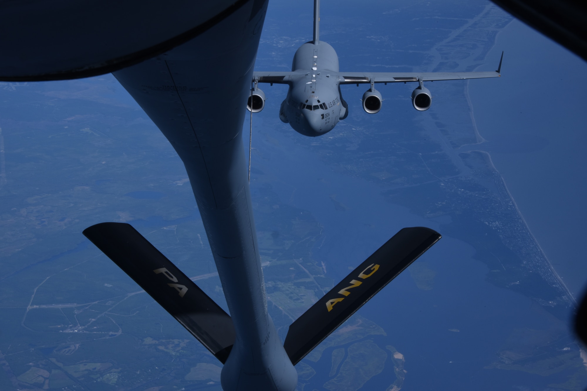 A C-17 Globemaster III trails a KC-135 Stratotanker before conducting air refueling operations near the coast of N.C. Sept. 28, 2018. The KC-135 can deliver up to 4,800 pounds or 716 gallons of jet fuel per minute. (U.S. Air National Guard photo by Staff Sgt. Bryan Hoover)