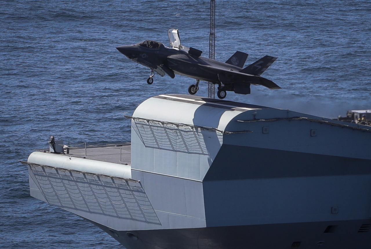 An F-35 takes off  from a ship.