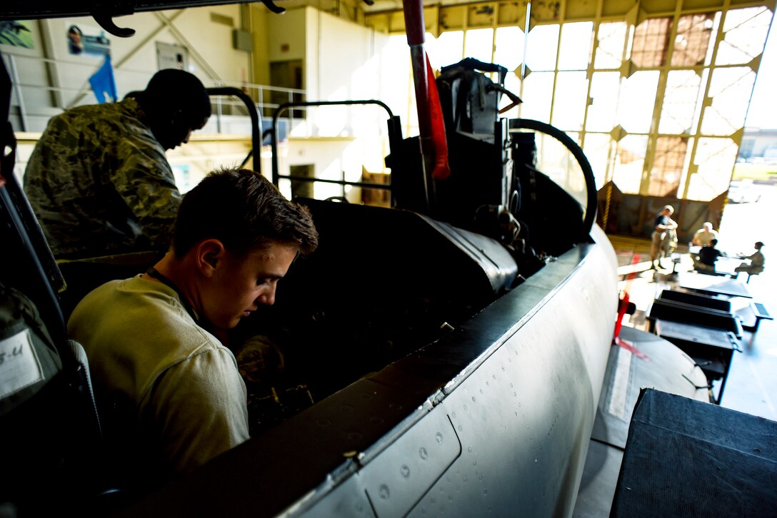 Electrical and environmental systems apprentice course Airmen replace components on an F-15 Eagle.