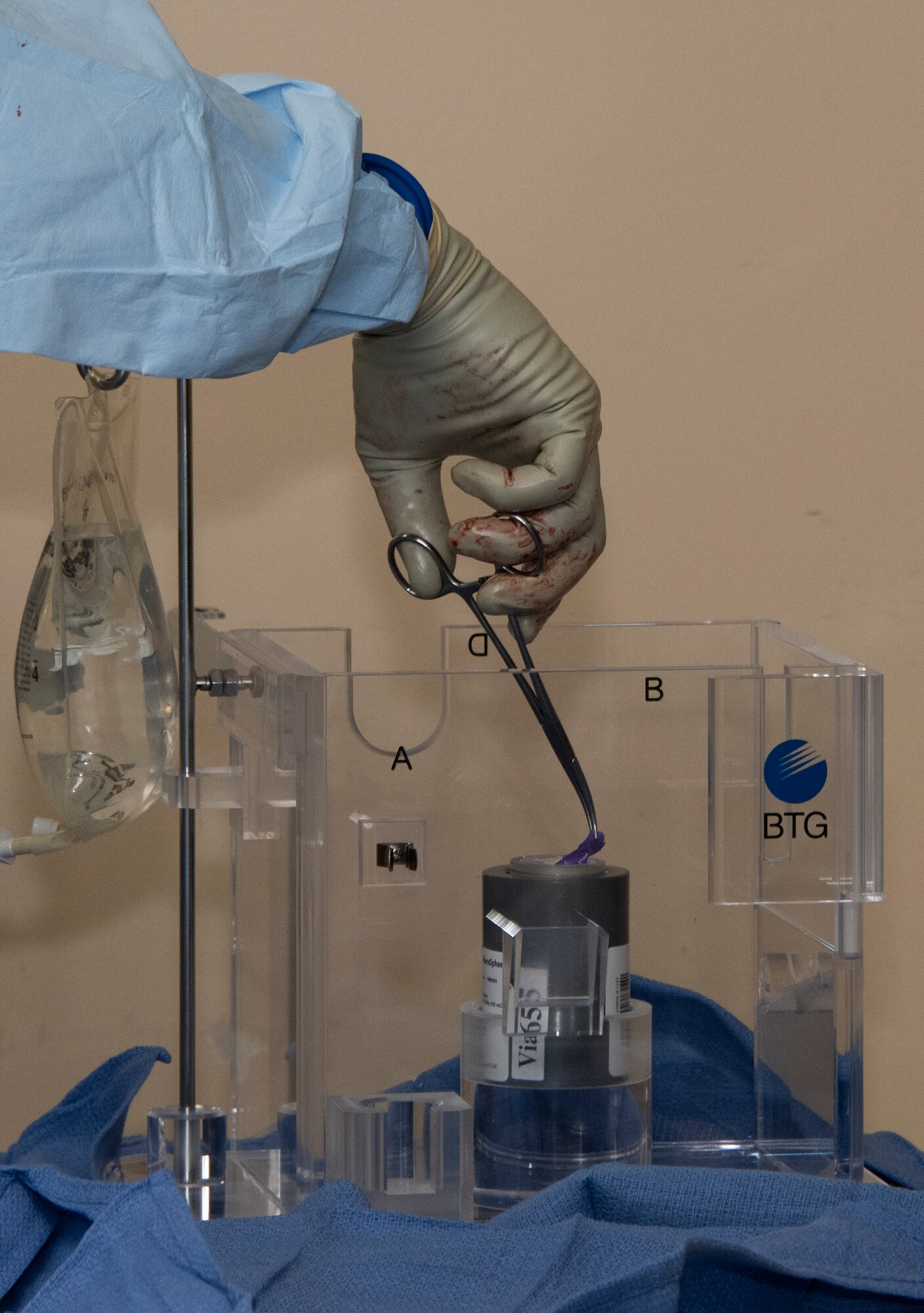 U.S. Air Force doctors prepare a high dose of Yttrium-90 radioactive beads during a procedure at David Grant U.S. Air Force Medical center, Sept. 7, 2018, Travis Air Force Base, Calif. The Y-90 radioembolization is an advanced and minimally invasive method utilized to treat cancer by delivering millions of tiny radioactive beads inside the blood vessels that feed a tumor. The high dose of targeted radiation prospectively kills the tumor while sparing normal tissue. This was the first time the treatment was performed at DGMC. (U.S. Air Force photo by Heide Couch)