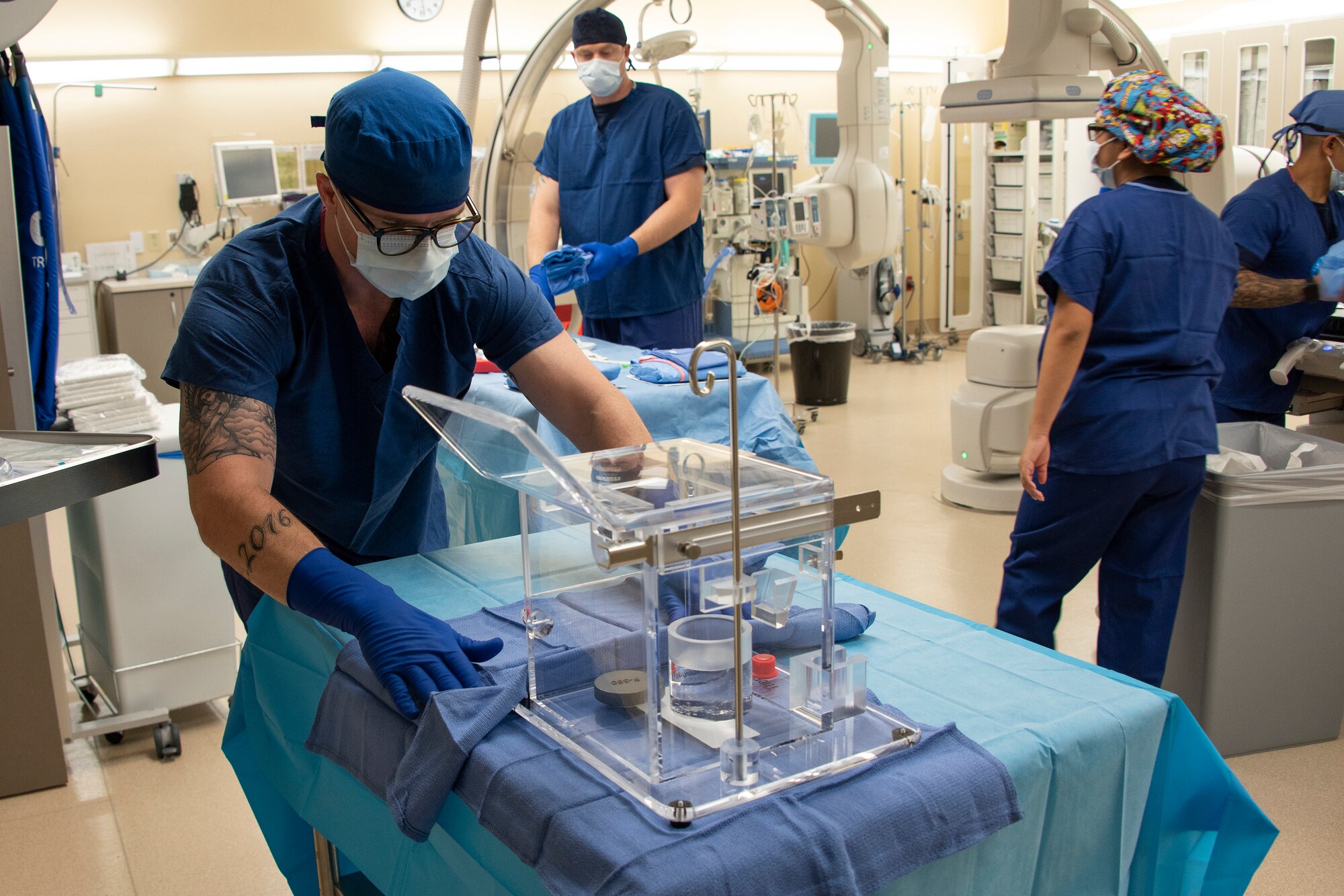 U.S. Air Force Senior Airman Justin Ritzel, 60th Diagnostics and Therapeutics Squadron, prepares a tray of specialized medical equipment ahead of an Yttrium-90 radioembolization procedure for a patient with liver cancer, Sept. 7, 2018, Travis Air Force Base, Calif. The Y-90 radioembolization is an advanced and minimally invasive method utilized for this disease by delivering millions of tiny radioactive beads inside the blood vessels that feed a tumor. The high dose of targeted radiation prospectively kills the tumor while sparing normal tissue. This was the first time the treatment was performed at David Grant U.S. Air Force Medical Center. (U.S. Air Force photo illustration by Josh Mahler)