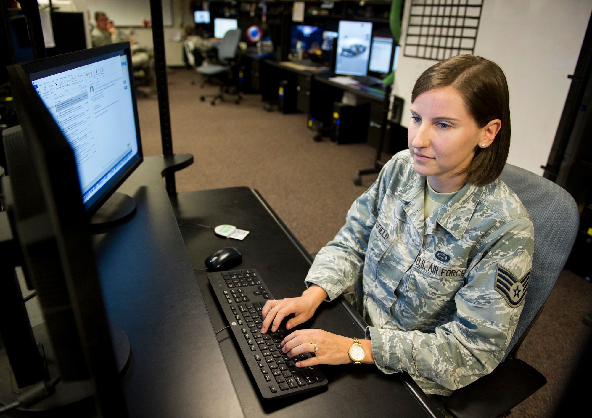 Staff Sgt. Elizabeth Caulfield, Signals Analysis Squadron scientific and technical signals analyst, conducts mission operations July 11 at the National Air and Space Intelligence Center on Wright-Patterson Air Force Base, Ohio. Caulfield was named one of the 12 Outstanding Airmen of the Year for the Air Force. (U.S. Air Force photo/ Senior Airman Michael Hunsaker)