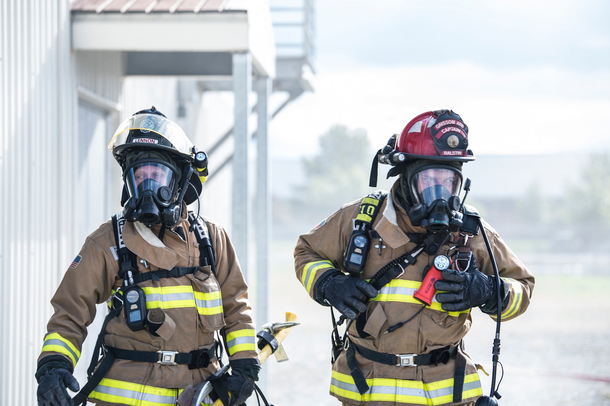 Thomas Lennon, Grissom Fire Department firefighter, and William Ralstin, Grissom Fire Department captain, prepare to enter the Smokehouse, a fire training simulator at Grissom Air Reserve Base, Ind., Sept. 26, 2018. Grissom firefighters train in the Smokehouse frequently to practice putting out fire and rescuing victims while in a controlled, monitored environment. (U.S. Air Force photo / Senior Airman Harrison Withrow)