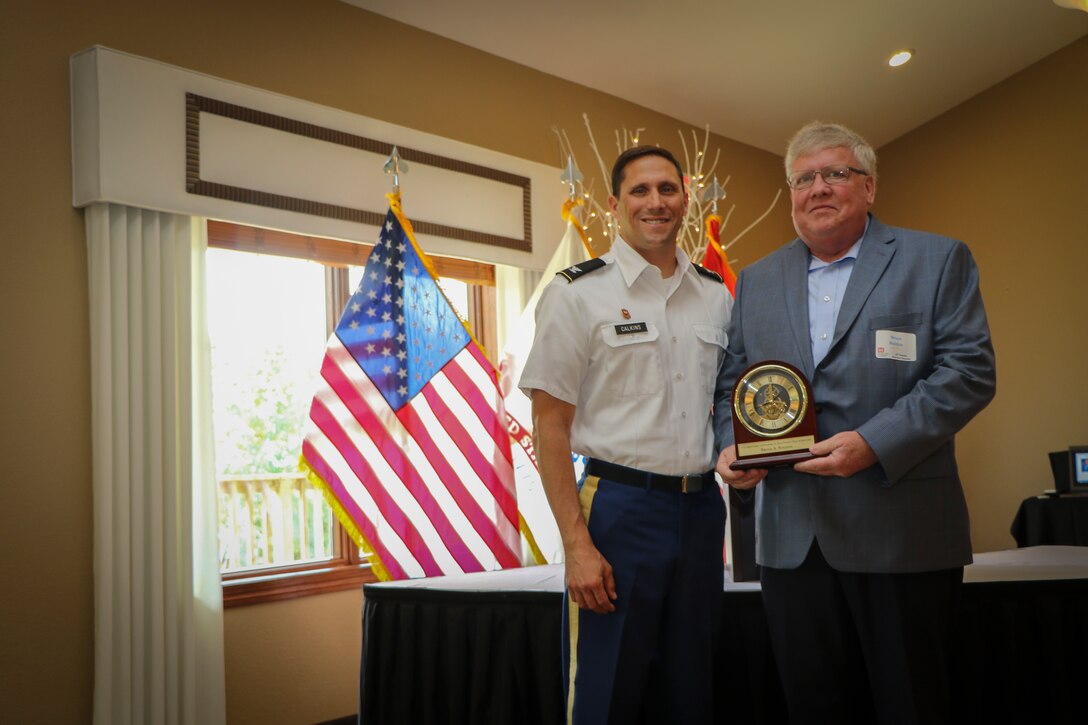 district commander poses with hall of fame recipient