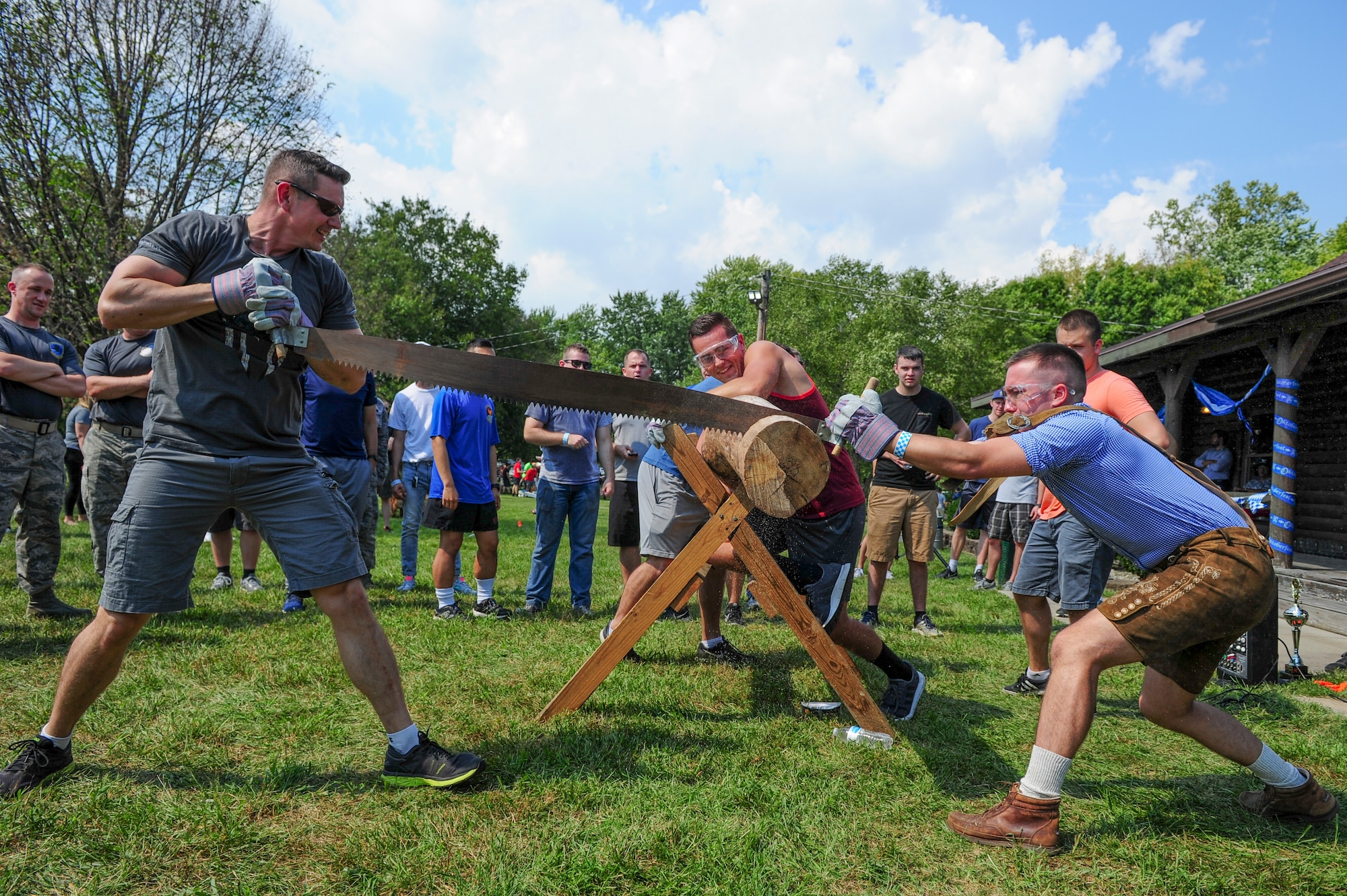 Members of the National Air and Space Intelligence Center compete in a log sawing competition during the National Air and Space Intelligence Center’s 50th Oktoberfest on Wright-Patterson Air Force Base, Ohio, Sept. 21, 2018. The groups of NASIC competed for bragging rights and the Oktoberfest Cup award. (U.S. Air Force photo by Senior Airman Michael Hunsaker)