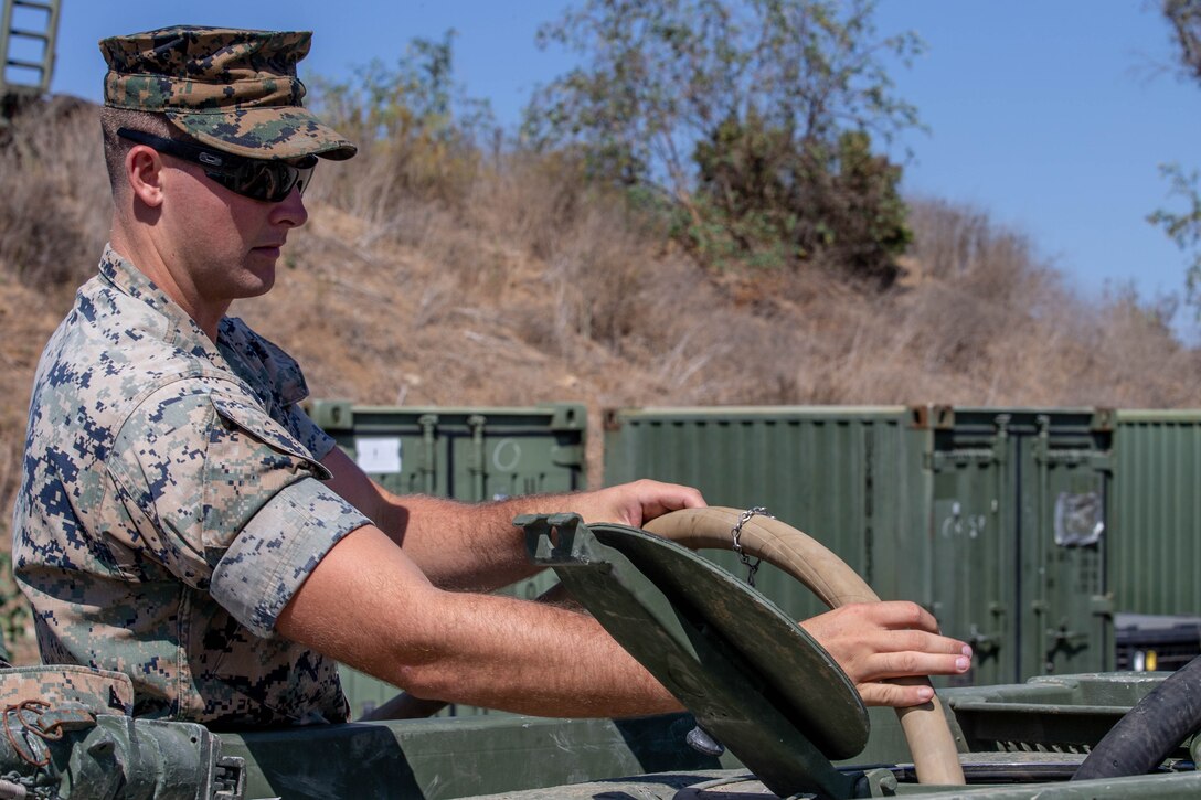 U.S. Marine Corps Cpl. Nathan Long, a combat engineer with Task Force Koa Moana, places a hose inside a lightweight water purification system (LWPS) at Marine Corps Base Camp Pendleton, Calif., Sept. 26, 2018. Long attended a class on the functions and capabilities of a LWPS. (U.S. Marine Corps photo by Cpl. Branden J. Bourque)