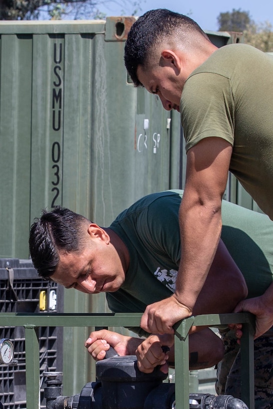 U.S. Marine Corps Sgt. Aaron Salcidosoto, bottom, a water support technician with the combat engineer detachment, teaches  Lance Cpl. Jose Jimenez Campos, a generator mechanic with the combat engineer detachment , both with Task Force Koa Moana, at Marine Corps Base Camp Pendleton, Calif., Sept. 26, 2018. Salcidosoto taught a class about the functions and capabilities of the lightweight water purification system. (U.S. Marine Corps photo by Cpl. Branden J. Bourque)