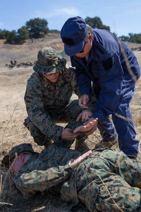 U.S. Marines Cpl. Kyle Mitchell, bottom, and Lance Cpl. Thomas E. McDonald, both military policemen with 1st Law Enforcement Battalion, Task Force Koa Moana (TF KM), demonstrate how to properly take down a detainee to a civilian role player during TF KM Mission Rehearsal Exercise at Marine Corps Base Camp Pendleton, Calif., July 17, 2018. The exercise confirms TF KM is capable of cross cultural interaction, instruction, and relationship building while training alongside partner nations in order to meet Theater Security Cooperation engagement objectives. (U.S. Marine Corps photo by Staff Sgt. Gabriela Garcia)