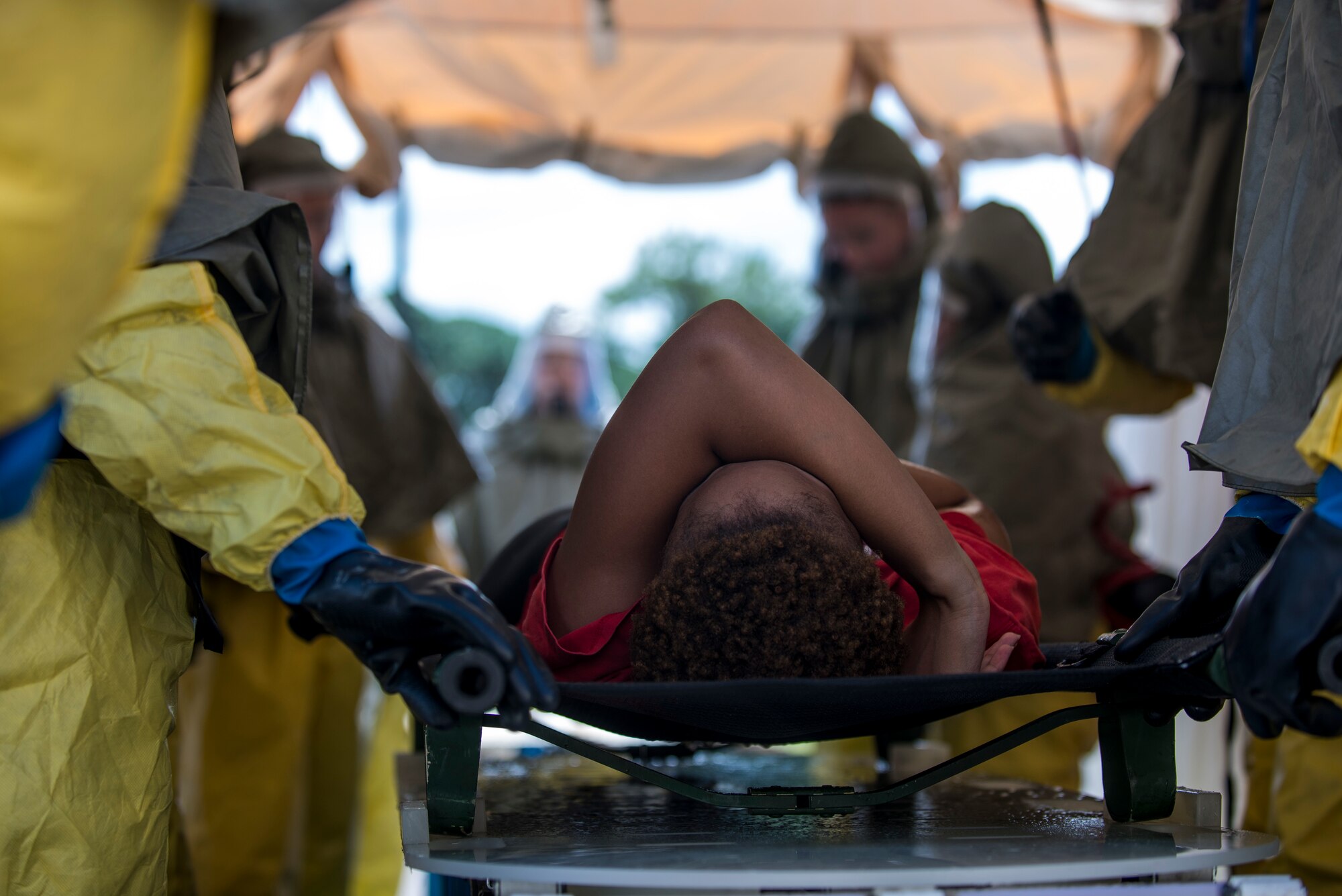 A patient is slid through a simulated decontamination tent during a 6th Air Mobility Wing operational readiness assessment (ORA) Oct. 4, 2018 at MacDill Air Force Base, Fla.