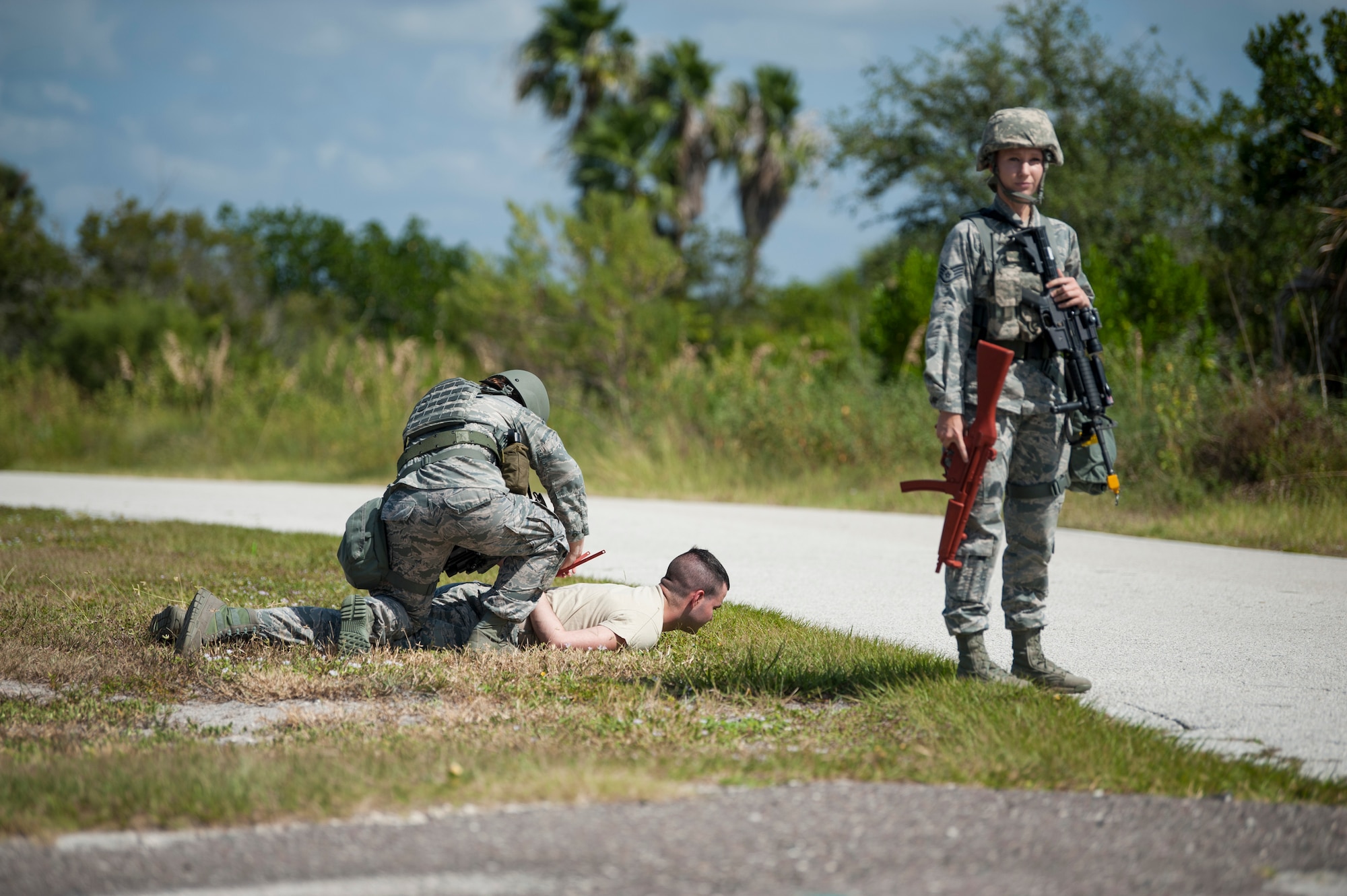 6th Security Forces Squadron defenders detain an mock intruder at a simulated forward operating position during a 6th Air Mobility Wing operational readiness assessment (ORA), Oct. 4, 2018 at MacDill Air Force Base, Fla.