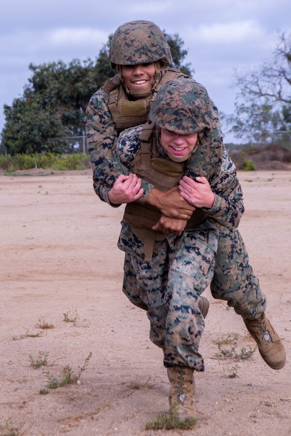 U.S. Marine Corps Sgt. Xavier Tunstall, an administration chief, top, and Cpl. Christopher Tarallo, an administrator, both with Task Force Koa Moana, perform a buddy carry during a Combat Lifesaver (CLS) course at Marine Corps Base Camp Pendleton, Calif., Sept. 20, 2018. The CLS course taught Marines how to properly apply life-saving interventions in tactical combat situations. (U.S. Marine Corps photo by Cpl. Branden J. Bourque)
