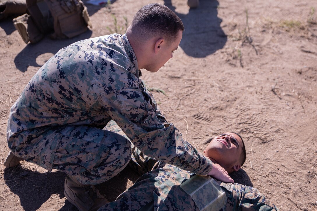 U.S. Marine Corps Cpl. Christopher Tarrallo, left, an administrator, top, performs broken bone checks on Sgt. Xavier Tunstall, an administration chief, both with Task Force Koa Moana, during a Combat Lifesaver (CLS) course at Marine Corps Base Camp Pendleton, Calif., Sept. 20, 2018. The CLS course taught Marines how to properly apply life-saving medical treatments to injured service members in any environment. (U.S. Marine Corps photo by Cpl. Branden J. Bourque)
