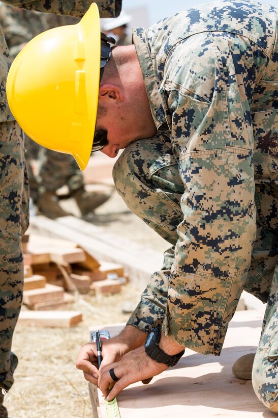 U.S. Marine Corps Cpl. Braiden M. Wadin, a combat engineer with Bravo Company, 7th Engineer Support Battalion, Task Force Koa Moana (TF KM), measures a piece of wood during the construction of a South West Asia hut during the TF KM Mission Rehearsal Exercise, at Marine Corps Base Camp Pendleton, Calif., July 18, 2018. The exercise confirmed TF KM is capable of cross cultural interaction, instruction, and relationship building while training alongside partner nations in order to meet Theater Security Cooperation engagement objectives. (U.S. Marine Corps photo by Staff Sgt. Gabriela Garcia)