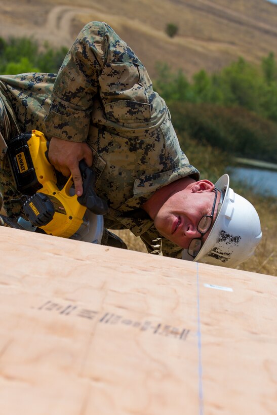 U.S. Marine Corps Lance Cpl. Caleb E. Pratt, a combat engineers with Bravo Company, 7th Support Battalion, Task Force Koa Moana (TF KM), confirms a measurment during the construction of a South West Asia hut, part of the TF KM Mission Rehearsal Exercise, at Marine Corps Base Camp Pendleton, Calif., July 18, 2018. The exercise confirmed TF KM is capable of cross cultural interaction, instruction, and relationship building while training alongside partner nations in order to meet Theater Security Cooperation engagement objectives. (U.S. Marine Corps photo by Staff Sgt. Gabriela Garcia)