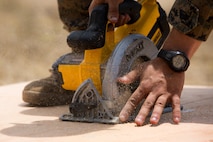 U.S. Marine Corps Cpl. Wendell C. Smith, a combat engineer with Bravo Company, 7th Engineer Support Battalion, Task Force Koa Moana (TF KM), uses a Miter saw during the construction of a South West Asia hut during the TF KM Mission Rehearsal Exercise, at Marine Corps Base Camp Pendleton, Calif., July 18, 2018. The exercise confirmed TF KM is capable of cross cultural interaction, instruction, and relationship building while training alongside partner nations in order to meet Theater Security Cooperation engagement objectives. (U.S. Marine Corps photo by Staff Sgt. Gabriela Garcia)