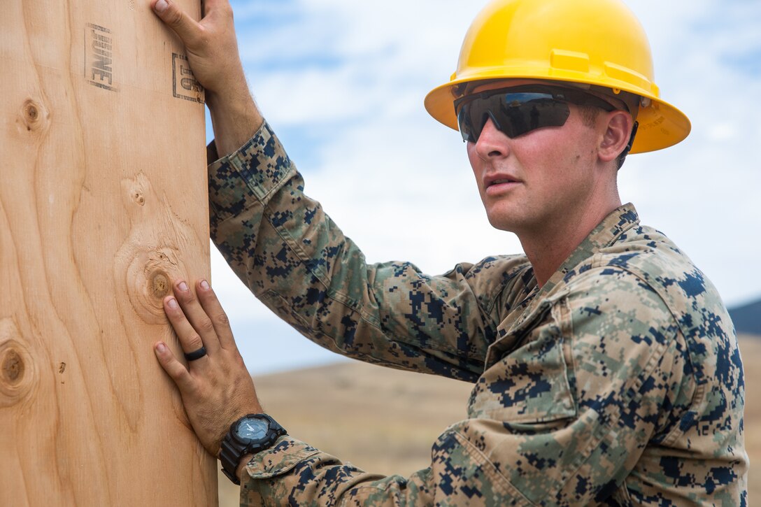 U.S. Marine Corps Cpl. Braiden M. Wadin, a combat engineer with Bravo Company, 7th Engineer Support Battalion, Task Force Koa Moana (TF KM), holds a wooden wall during the construction of a South West Asia hut during the TF KM Mission Rehearsal Exercise, at Marine Corps Base Camp Pendleton, Calif., July 18, 2018. The exercise confirmed TF KM is capable of cross cultural interaction, instruction, and relationship building while training alongside partner nations in order to meet Theater Security Cooperation engagement objectives. (U.S. Marine Corps photo by Staff Sgt. Gabriela Garcia)