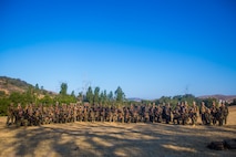 U.S. Marines with Task Force Koa Moana (TF KM) pose for a group photo after a six mile hike during the TF KM Mission Rehearsal Exercise at Marine Corps Base Camp Pendleton, Calif., July 20, 2018. The exercise increased the task force capability and readiness to execute theatre security cooperation events during TF KM's deployment. (U.S. Marine Corps photo by Staff Sgt. Gabriela Garcia)