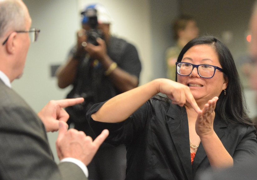 Tracy T. Tao-Moore, the lead graphic artist for the Mission Support Branch, Technology Division at Army Human Resources Command’s Personnel Information Systems Directorate, signs prior to receiving the Department of Defense Disability Achievement and Recognition Award at a Pentagon ceremony.