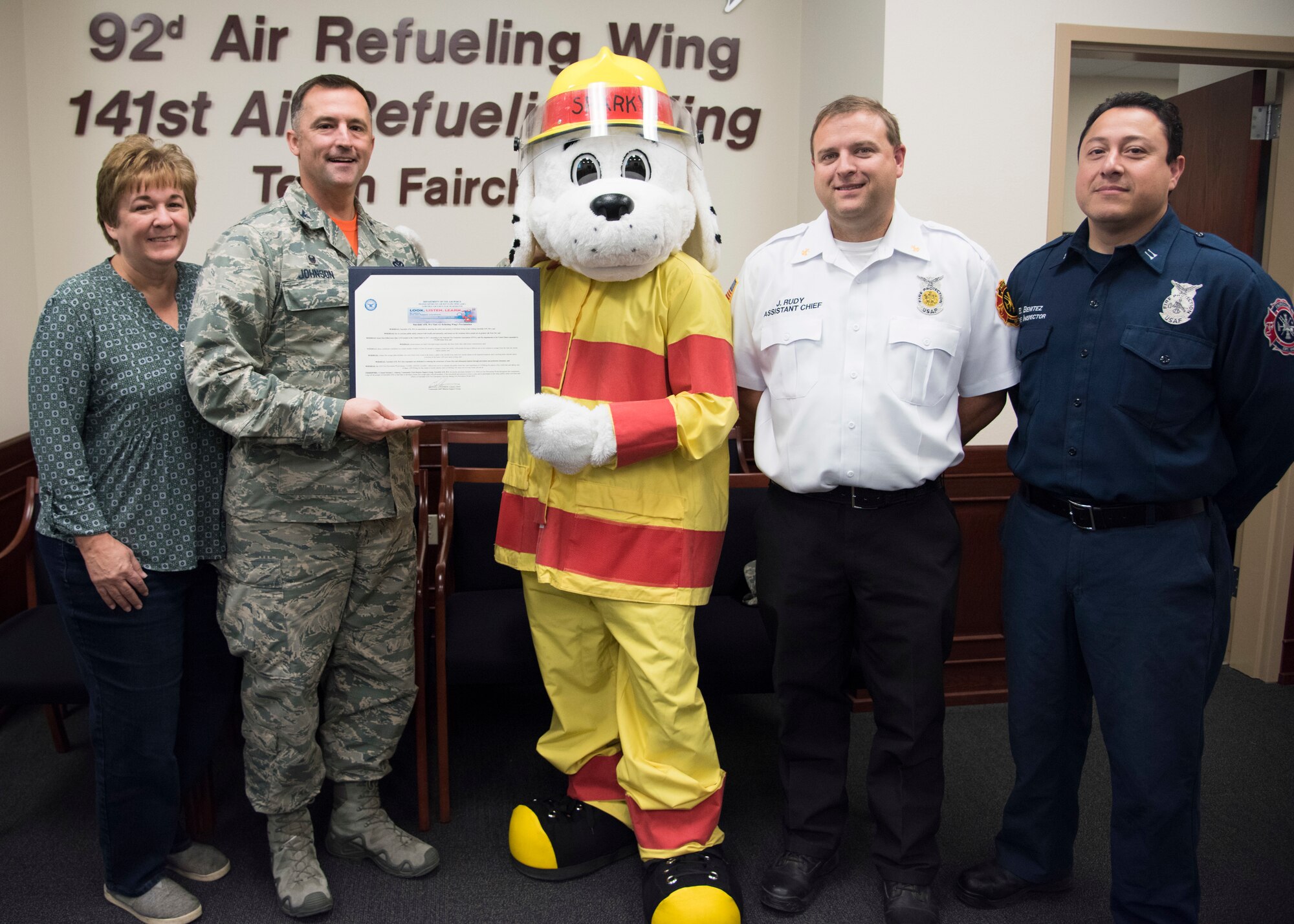 Col. Michael Johnson, 92nd Mission Support Group commander, and several Team Fairchild firefighters hold a signed proclamation declaring the start of Fire Prevention Week at Fairchild Air Force Base, Washington, Oct. 5, 2018. Fire safety proclamation signings are preformed nationwide by local leaders to give greater awareness to the annual event, which honors the devastation of the Great Chicago Fire in 1871, and prompted increased fire safety standards across the country. (U.S. Air Force Photo/ Senior Airman Ryan Lackey)