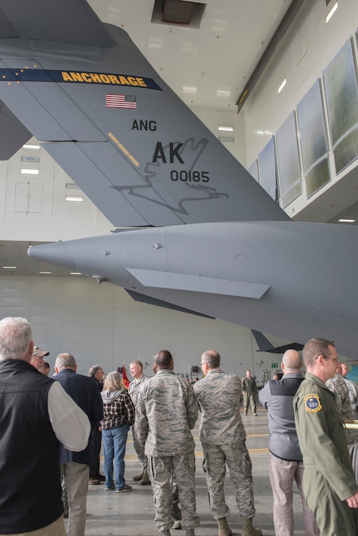 Members of the Alaska Air National Guard’s 176th Wing and the Regular Air Force’s 3rd Wing witnessed the unveiling of a new tail flash on the C-17 Globemaster IIIs assigned to the 176th Wing’s 144th Airlift Squadron at Joint Base Elmendorf-Richardson, Alaska, Oct. 1, 2018. The new tail flash depicts a wolf head, (the 144th AS’s emblem), on one side, and a firebird (the 517th AS’s emblem), of equal size on the other. (U.S. Air National Guard photo by Tech. Sgt. N. Alicia Halla)