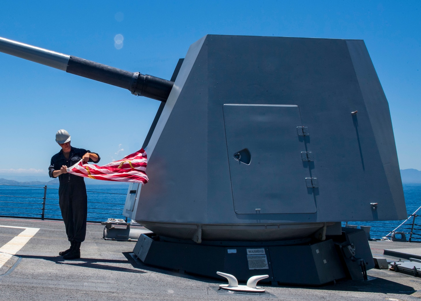PORT MORESBY, Papua New Guinea (Oct. 6, 2018) Boatswain's Mate Seaman Josh Saunders prepares to hoist the Union Jack aboard Arleigh-Burke class guided-missile destroyer USS Michael Murphy (DDG 112) as it arrives in Papua New Guinea. As the first U.S. Navy ship to visit Port Moresby since USS Comstock (LSD 45) in 2017, Michael Murphy arrives as the nation prepares to host the Asia-Pacific Economic Cooperation (APEC) Leaders’ Summit for the first time in Nov. 2018. Michael Murphy is forward-deployed to the U.S. 7th Fleet area of operations in support of security and stability in the Indo-Pacific region.