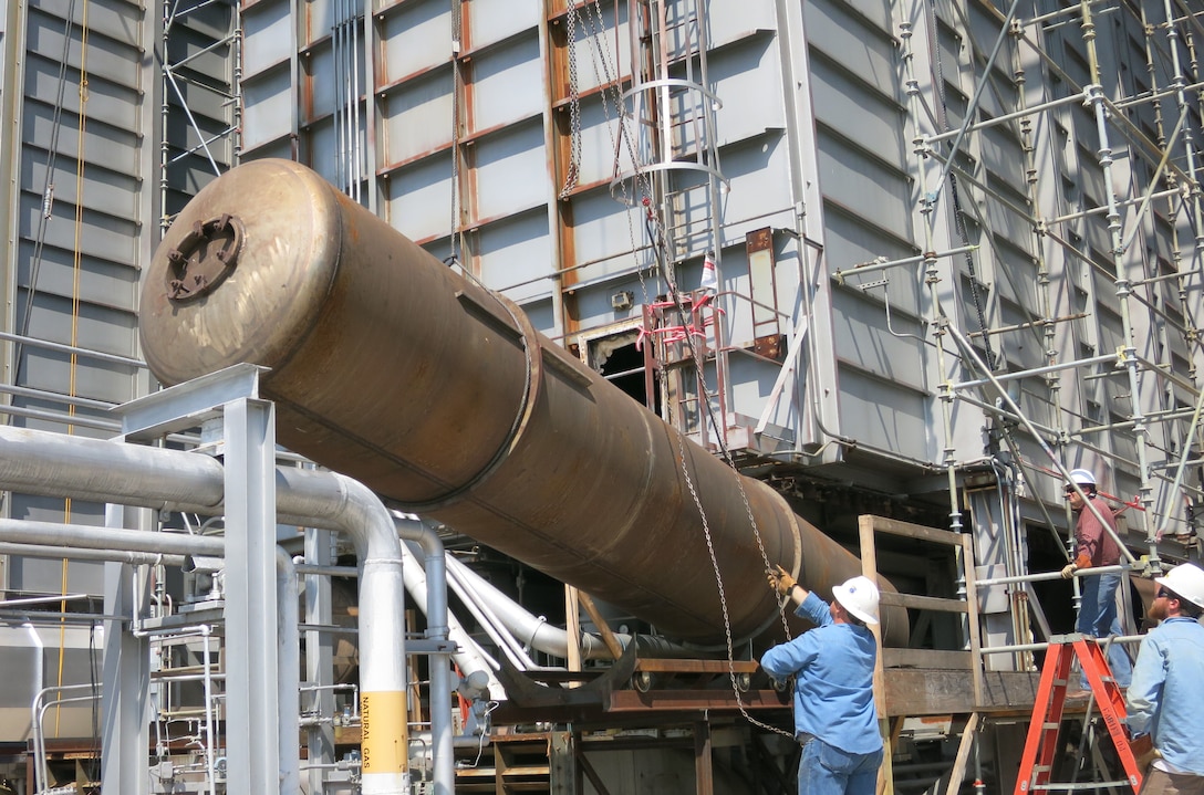 Workers remove one of lower headers at a C-Plant heater at the AEDC Engine Test Facility at Arnold Air Force Base. An innovative method was used when installing the new lower header ducts enabling craft crews to finish the project 7.5 weeks ahead of schedule with a cost savings of over $195,000. (AEDC photo)