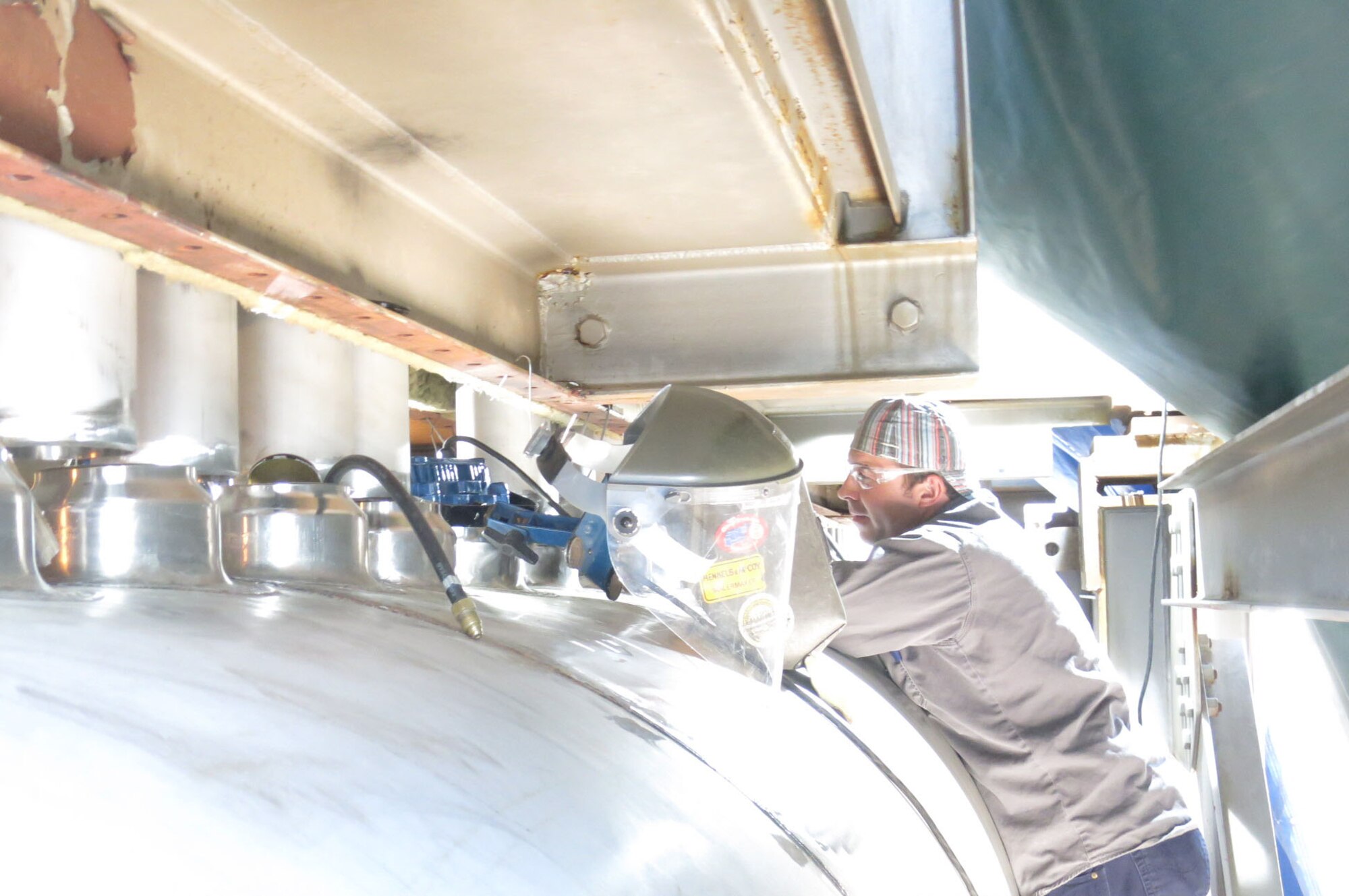 Boilermaker Mack Rogers works to install the header for one of the C-Plant heaters at the AEDC Engine Test Facility at Arnold Air Force Base. An innovative method was used when installing the new header ducts enabling craft crews to finish the project ahead of schedule. (AEDC photo)