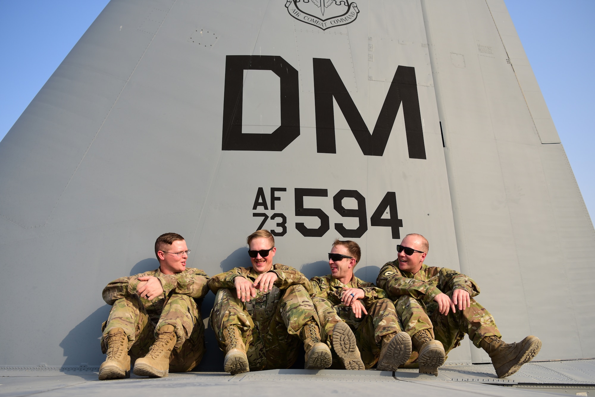 Maintainers from the 386th Expeditionary Aircraft Maintenance Squadron sit on the back of a 43rd Expeditionary Electronic Combat Squadron EC-130H aircraft Sept. 21, 2018, at an undisclosed location in Southwest Asia. The 43rd EECS and aircraft they fly provide communications jamming support to United States and coalition ground forces throughout the Central Command area of responsibility. (U.S. Air Force photo by Staff Sgt. Christopher Stoltz)