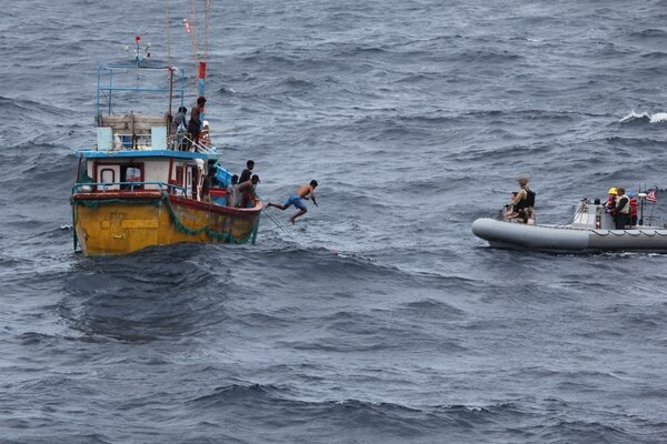 INDIAN OCEAN (Oct. 7, 2018) A Sri Lankan fisherman jumps and swims to a rigid-hull inflatable boat (RHIB) from the Arleigh Burke-class guided missile destroyer USS Decatur (DDG 73) after the ship stopped to render assistance to a stranded fishing vessel. After providing food and water, Decatur contacted the Sri Lankan authorities who came and towed the stranded vessel back to port. Decatur is forward deployed to the U.S. 7th Fleet area of operations in support of security and stability in the Indo-Pacific region.