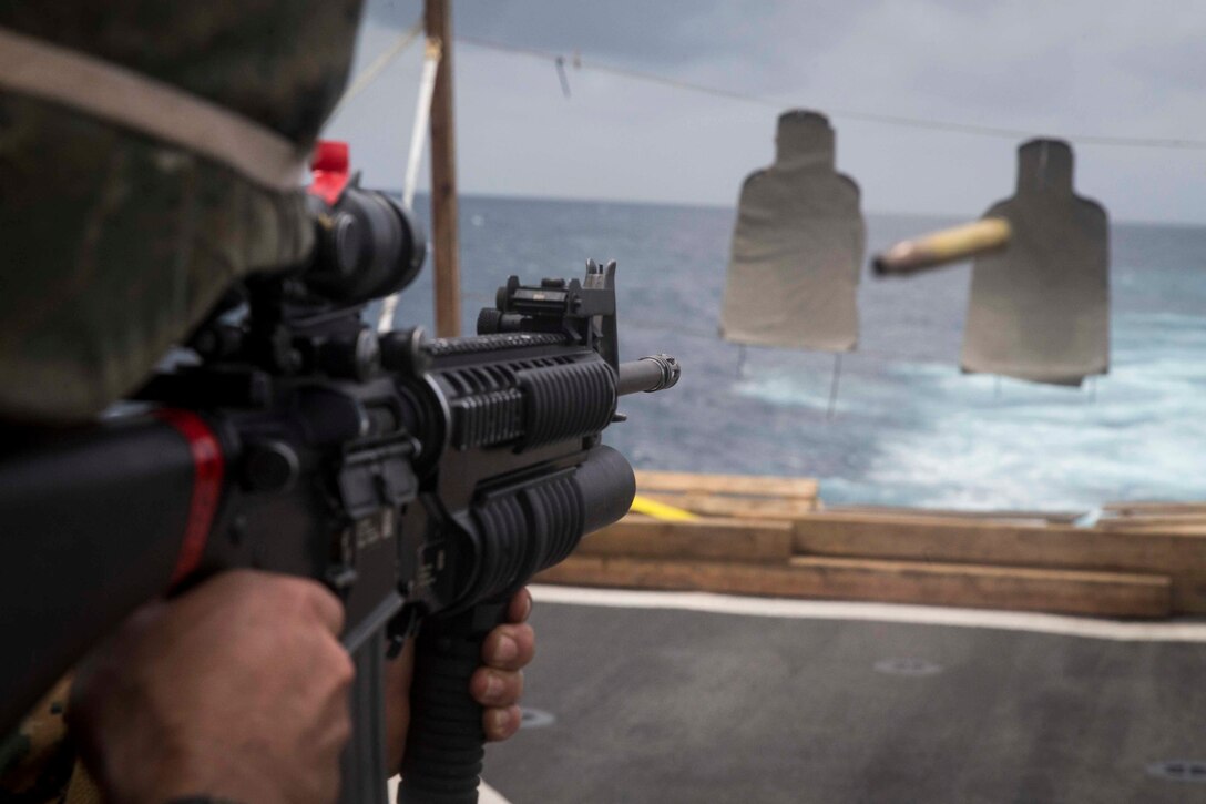 U.S. Marine Cpl. John Leos, a water support technician with Combat Logistics Battalion 13, 13th Marine Expeditionary Unit, fires his M16 rifle aboard the Whidbey Island-class dock landing ship USS Rushmore during a regularly scheduled deployment of Essex Amphibious Ready Group and 13th MEU. The Essex ARG/MEU team is a strong, flexible, responsive, and consistent force capable of maneuver warfare across all domains; it is equipped and scalable to respond to any crisis from humanitarian assistance and disaster relief to contingency operations.