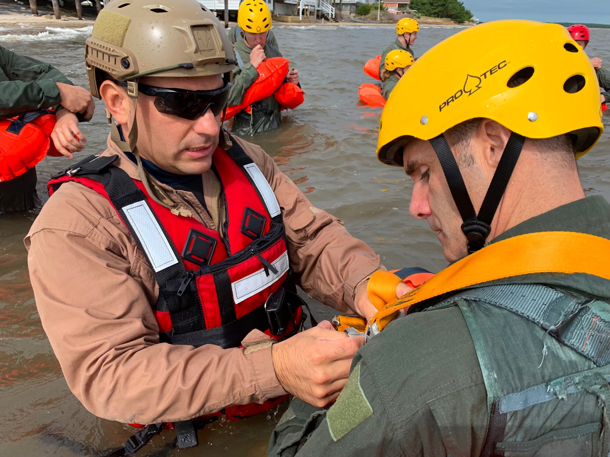 Tech. Sgt. Joseph Monreal, 436th Civil Engineer Squadron Survival, Evasion, Resistance and Escape instructor, teaches an Airman how to properly secure his flotation device during water survival training Sept. 27, 2018, at Bowers Beach, Del. The training provides aircrews with the skills and knowledge they need to survive if forced to egress over water.