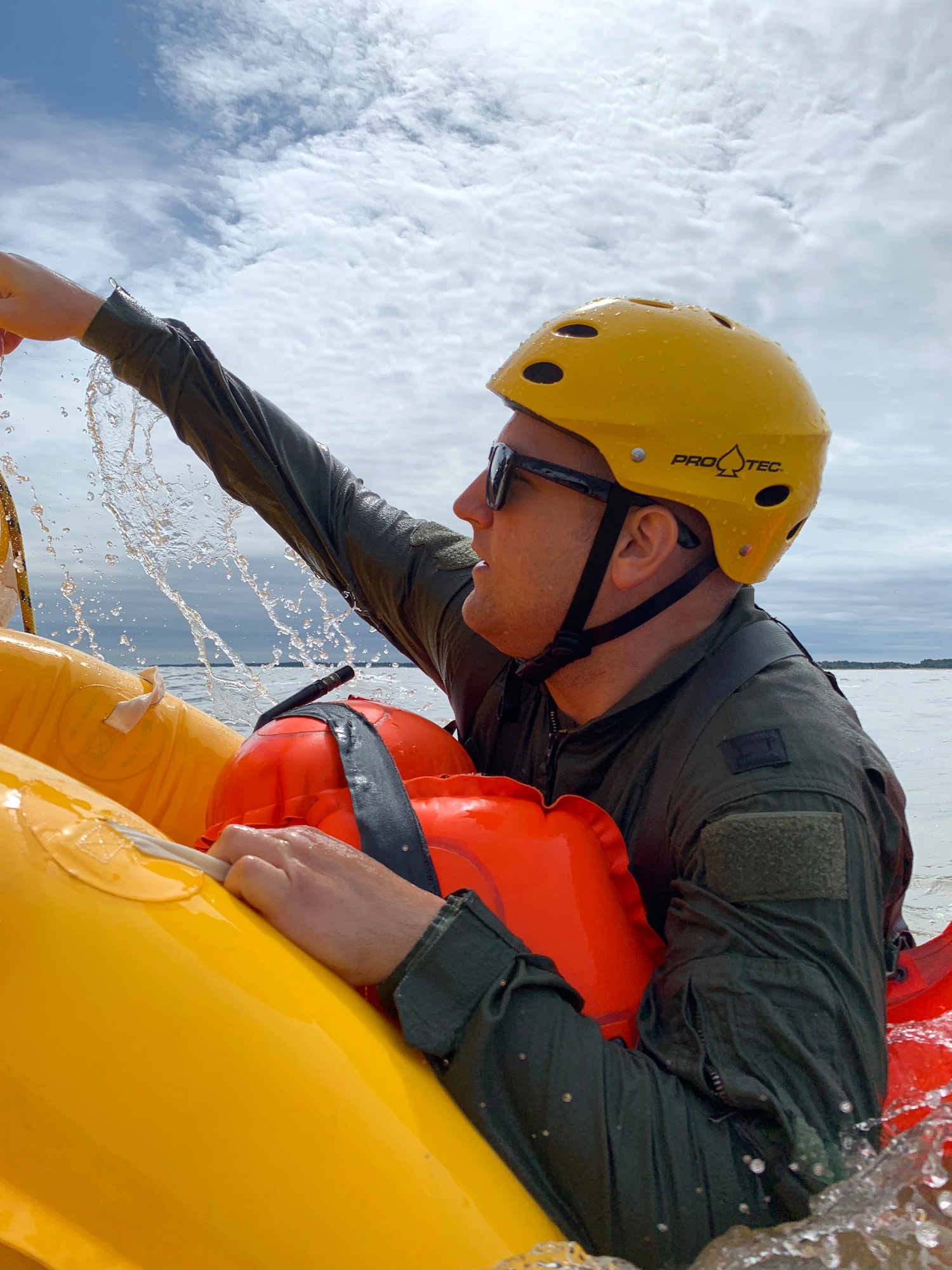 Capt. Alex Lapointe, 337 AS C-17 pilot from Westover Air Reserve Base, climbs into a raft floating in the Atlantic Ocean Sept. 27, 2018, about 200 yards from the coast of Bowers Beach, Del. The practical application of the water survival training is accomplished after several classroom training sessions.