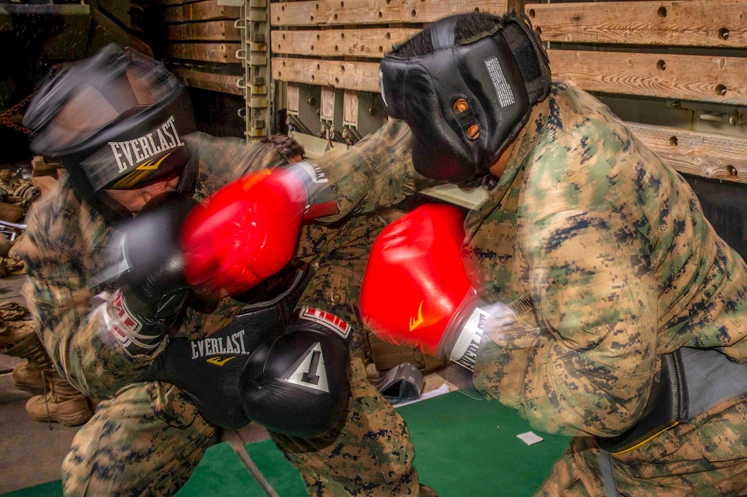 A marine punches another marine during sparring training.